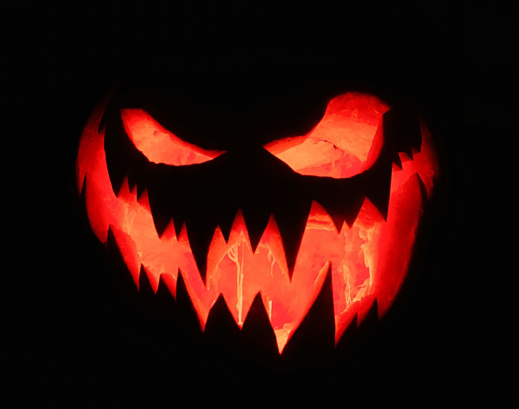 scary mouth jack o lantern lit at night